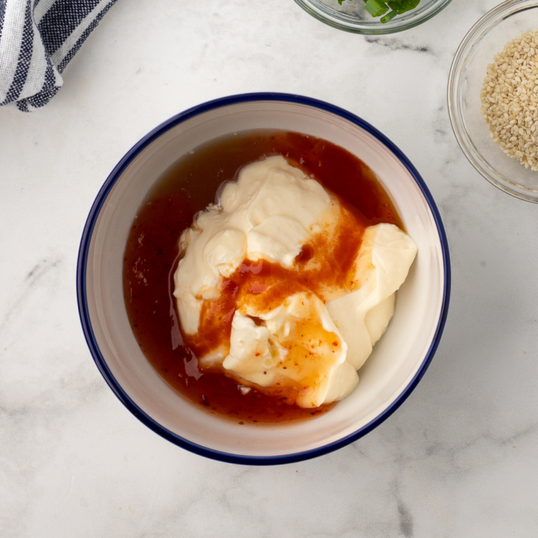 Creamy spicy bang bang sauce whisked smooth in small bowl