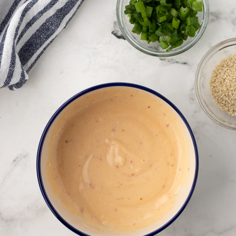 Creamy Bang Bang sauce whisked until smooth in small bowl