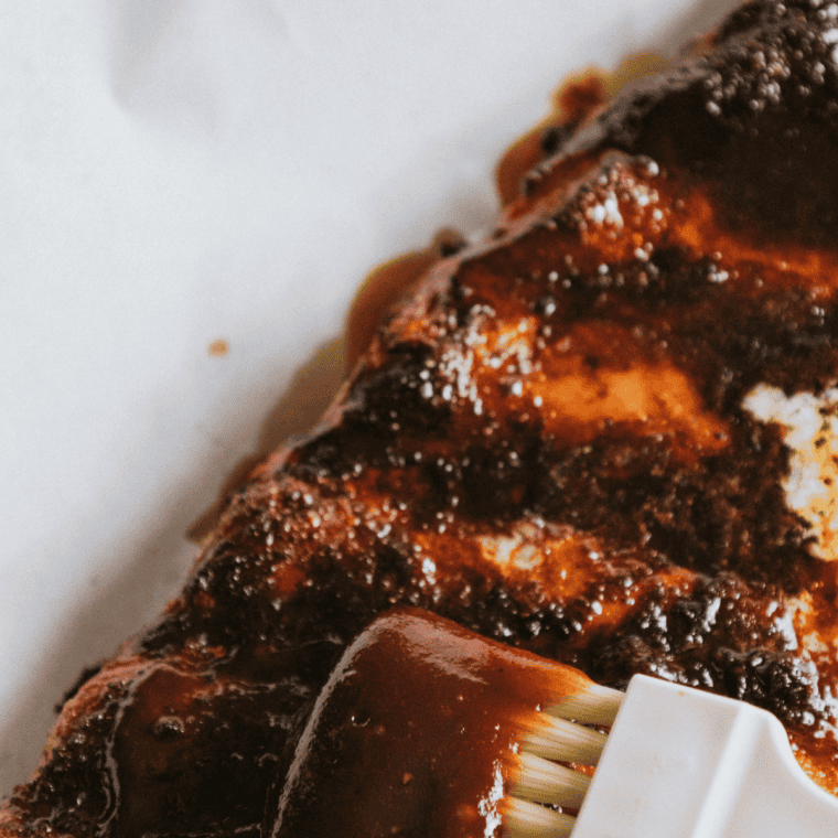 Air fryer beef ribs glazed and browned with visible bone and juicy interior.
