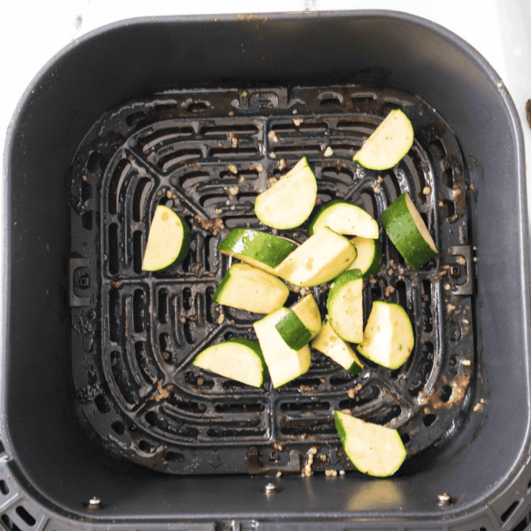 Golden air fryer zucchini half-moons cooked until tender and lightly browned