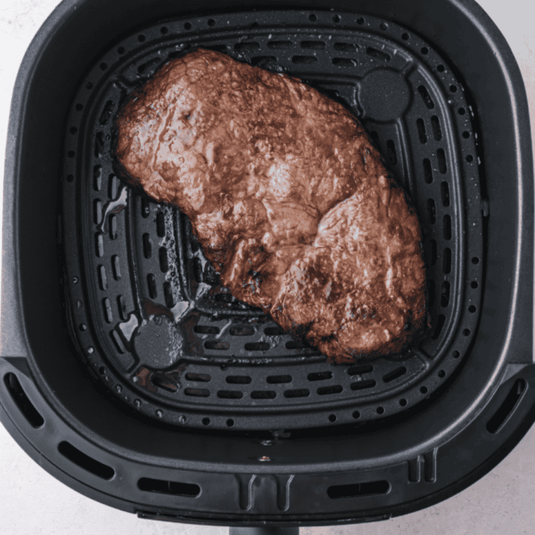 Air fryer eye of round steak with a caramelized crust, sliced thin against the grain