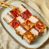 Plate of Air Fryer Siu Yuk with crispy crackling skin sliced into squares