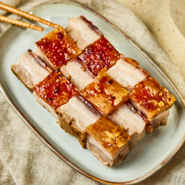 Plate of Air Fryer Siu Yuk with crispy crackling skin sliced into squares