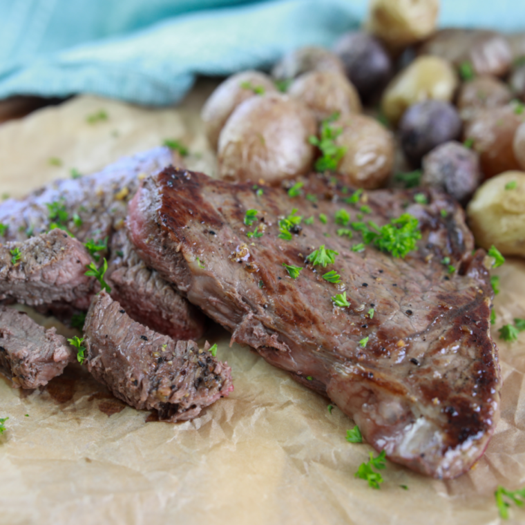 Air fryer steak served with roasted vegetables on dinner plate