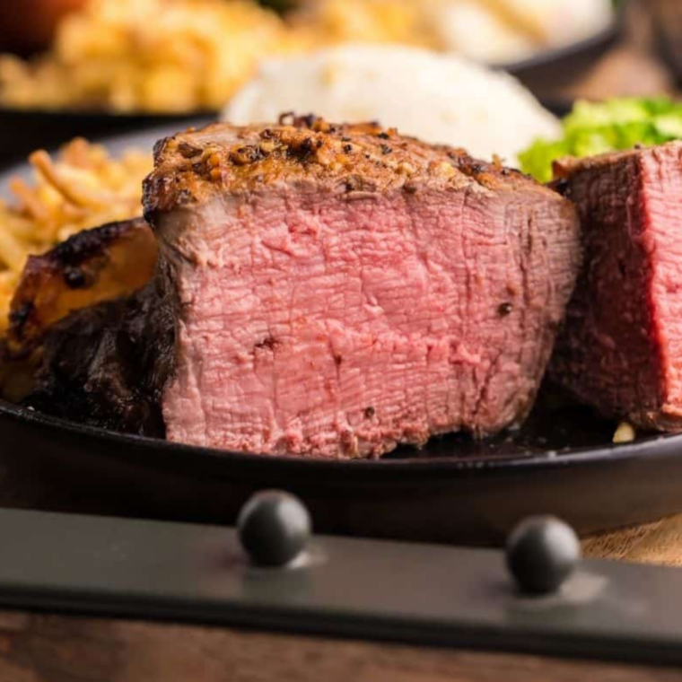 Juicy air fryer steak sliced with pink center and seasoning crust