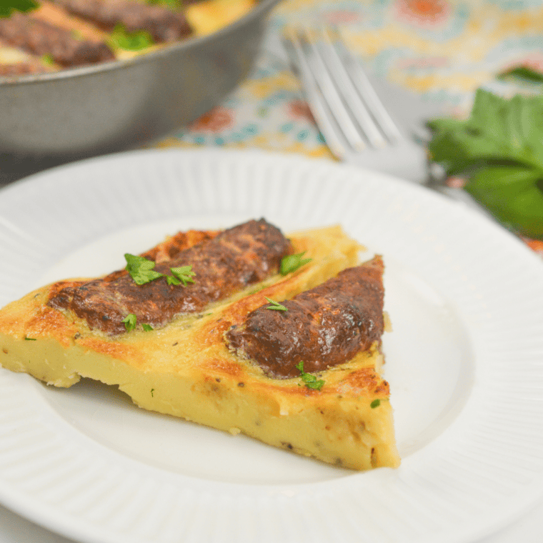 Close-up of air fryer toad in the hole with browned sausages baked in puffed batter