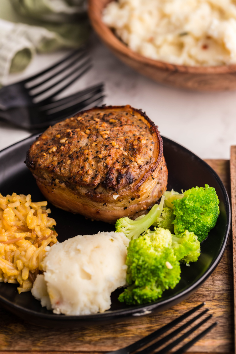 Ribeye steak topped with melted garlic butter and herbs