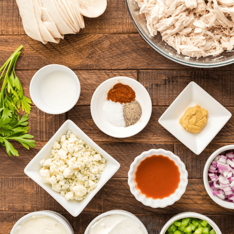 Ingredients for copycat Burger King Buffalo Sauce laid out on a counter: mayonnaise, Frank's RedHot sauce, ketchup, horseradish, Worcestershire sauce, lemon, and spices