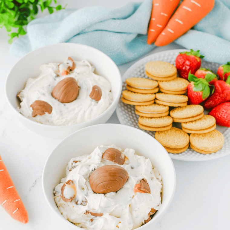 Creamy Cadbury Egg Dip topped with pastel Mini Eggs in a white serving bowl