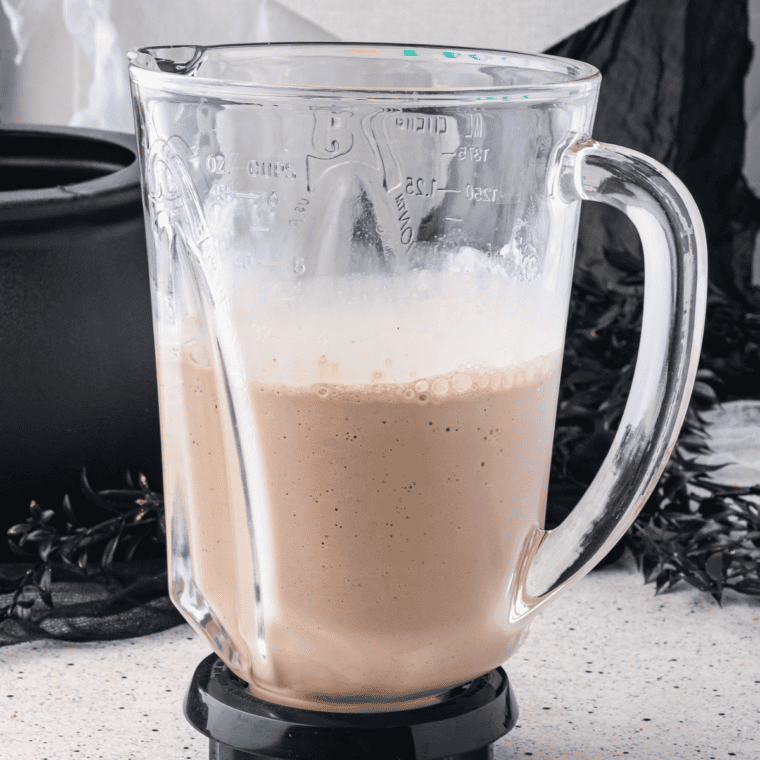 Thick, spoon-coating Caramel Macchiato Milkshake being checked for the perfect pourable consistency.