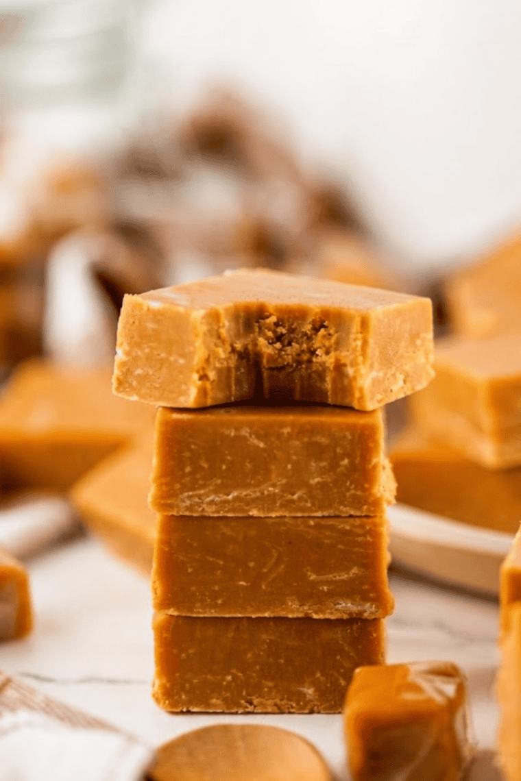 Marble fudge squares with chocolate and caramel swirls on a white plate.