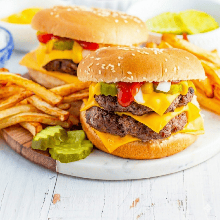 Homemade McDonald&rsquo;s double cheeseburger with two beef patties, cheese, pickles, ketchup, and mustard on a soft bun