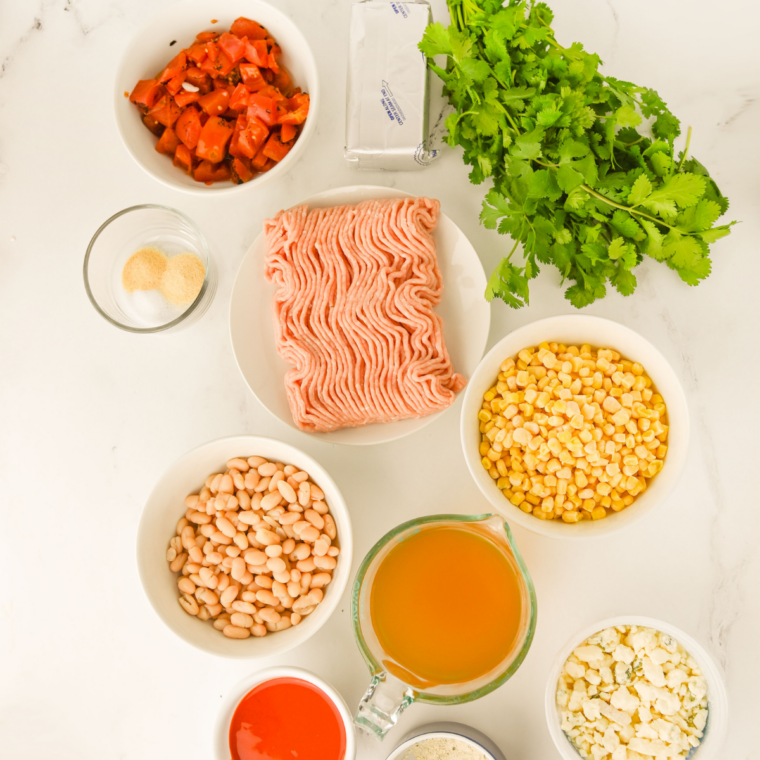 Ingredients needed for Crock Pot Buffalo Chicken Chili on kitchen table.
