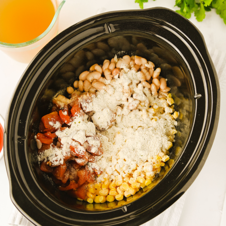 Beans, fire roasted tomatoes, and frozen corn added to the crock pot with cooked ground chicken
