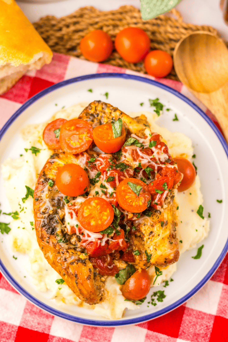 Shredded crockpot bruschetta chicken served with diced tomatoes and basil on top