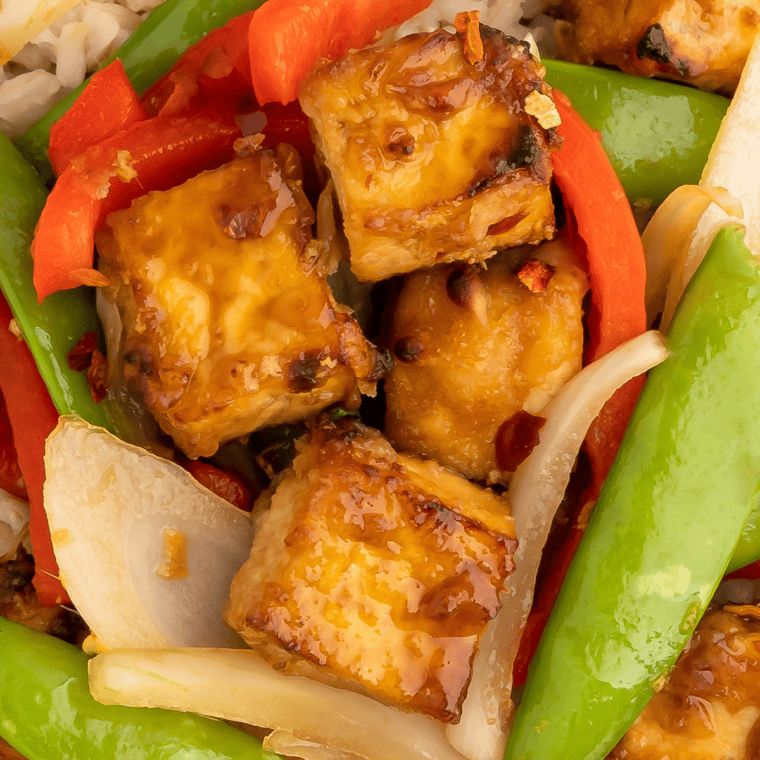 Greek tofu marinade on golden grilled tofu cubes with lemon, oregano, and fresh dill