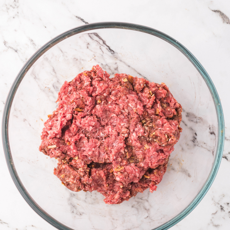 Dividing ground beef into small loose balls for thin McDonald&rsquo;s style burger patties
