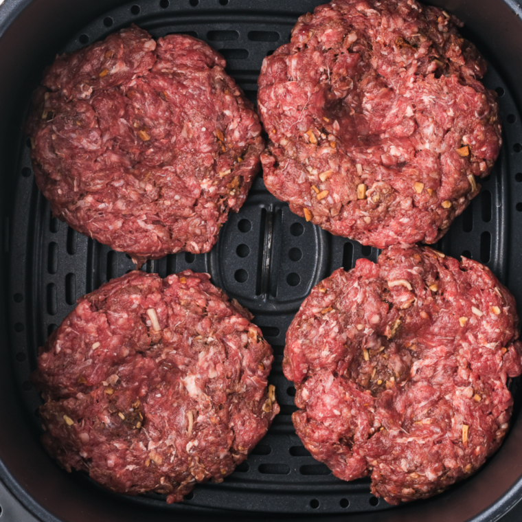Preheating cast iron skillet on high heat until smoking hot for searing burgers
