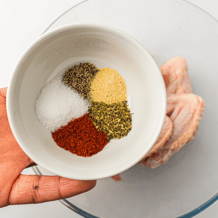 Whisking dried spices together into a uniform red-brown blend