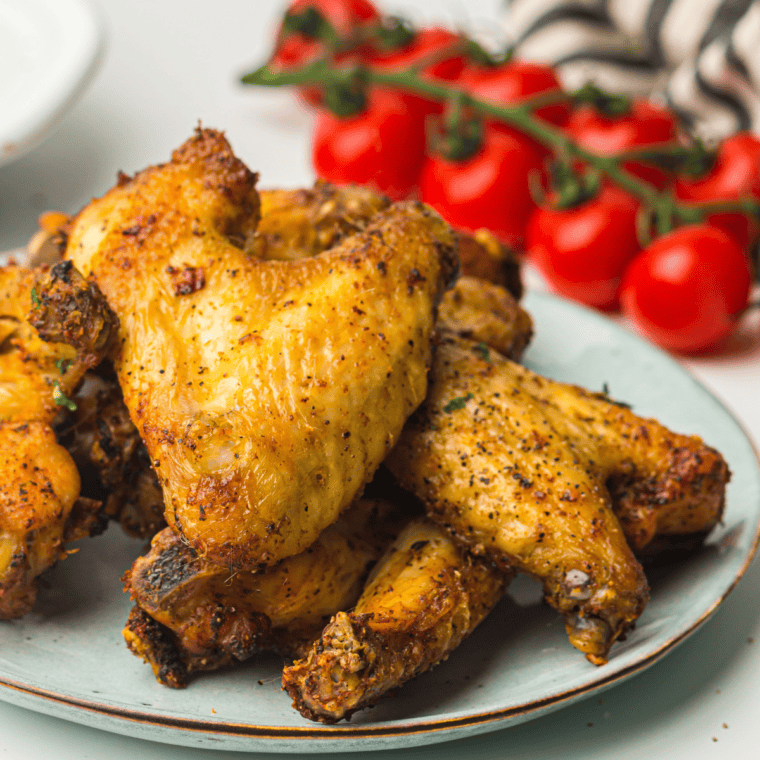 Seasoned chicken wings coated with Montreal chicken seasoning after air frying.