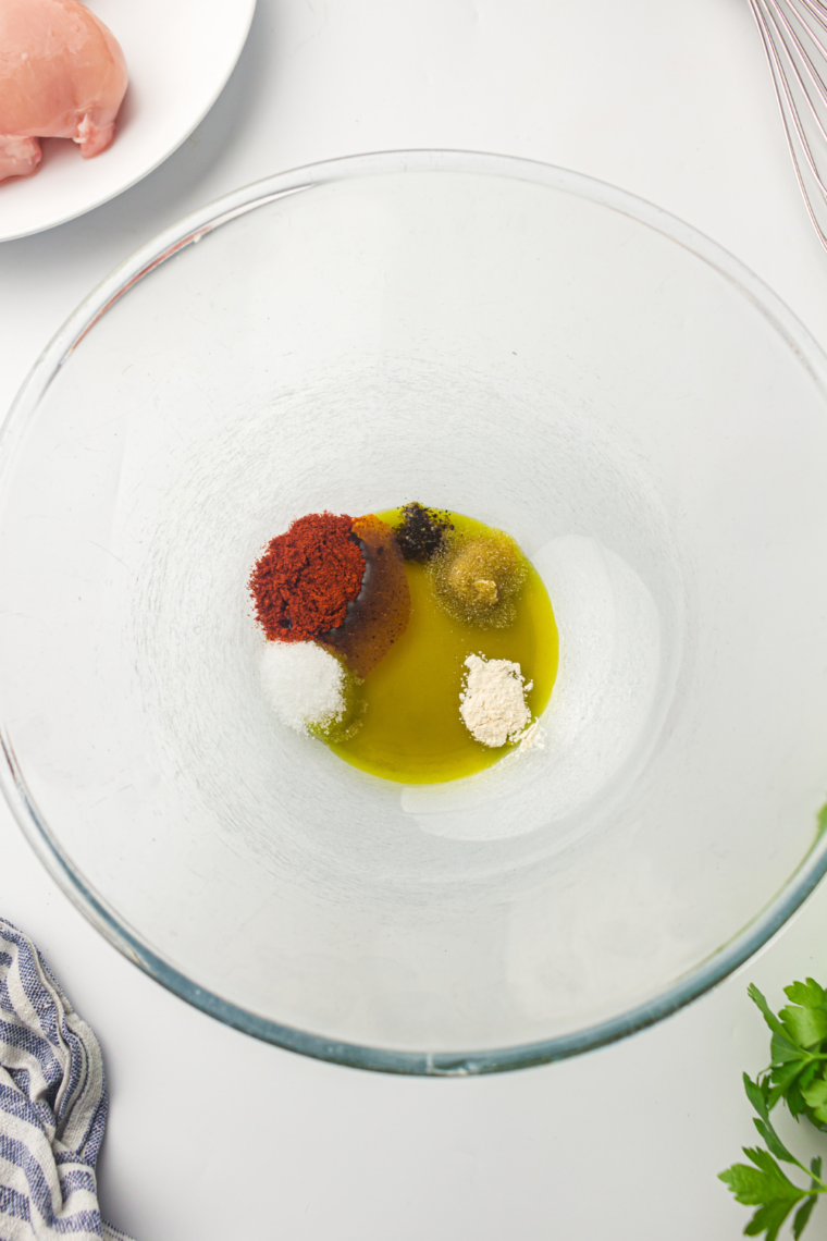 Whisking ginger-garlic marinade ingredients inside Ninja Crispi glass container