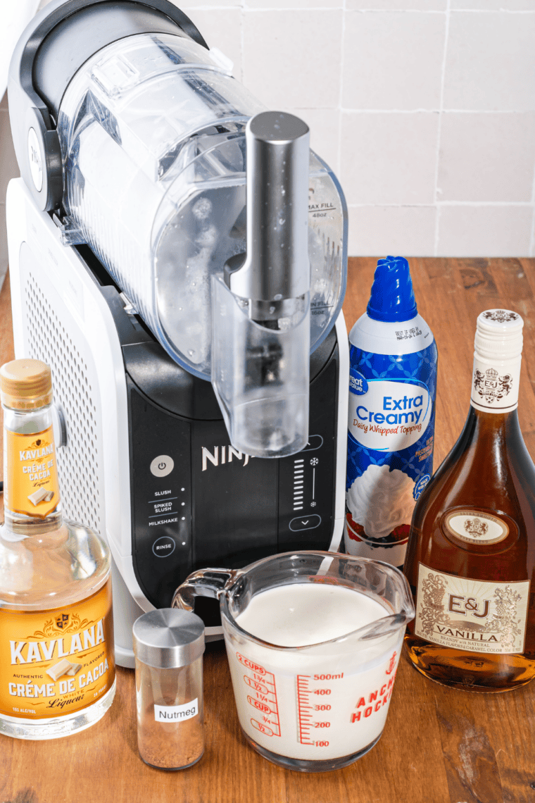 Pitcher with vanilla brandy, cr&egrave;me de cacao, and heavy cream being stirred together into a smooth mixture