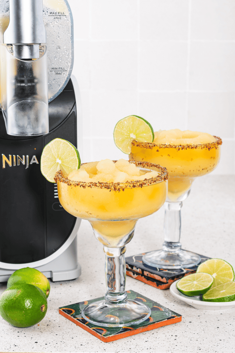 Ninja Slushi machine with vessel locked onto base and Spiked Slush setting selected for frozen mango margarita
