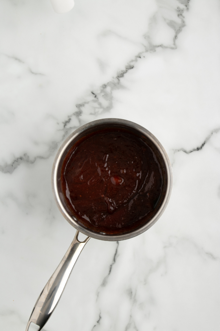 Homemade BoldBQ sauce gently simmering in a saucepan on stovetop