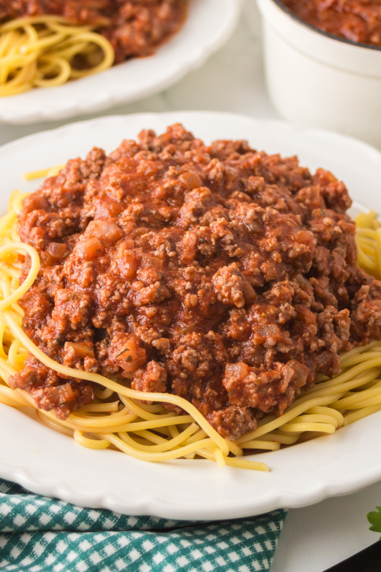 Slow cooker Bolognese sauce in rustic bowl with pasta
