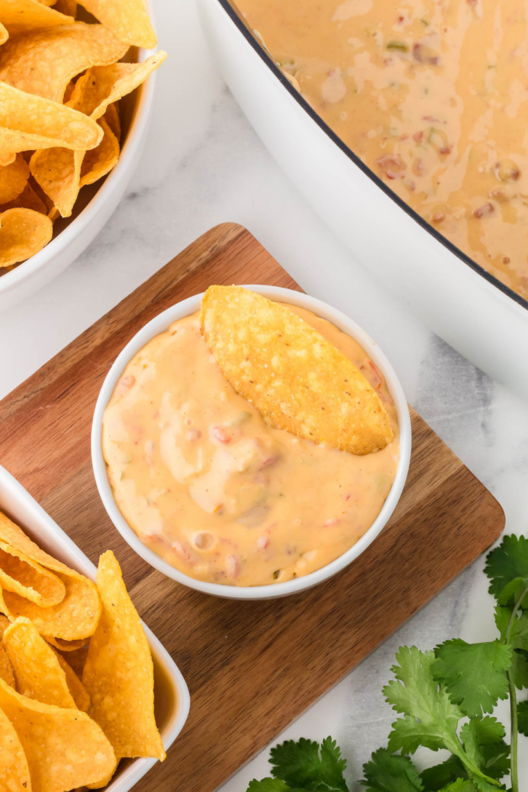 Slow cooker Velveeta queso bubbling into smooth creamy cheese dip for parties and game day
