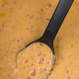Creamy slow cooker queso with Velveeta, Rotel, and seasoned beef. Ready in 2 hours, stays warm for parties, and only takes 10 minutes of prep!