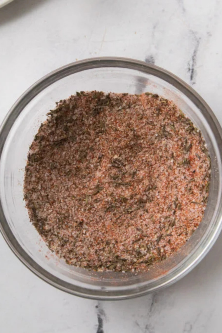 Whisking pot roast seasoning with a fork until the spices are evenly blended and fully combined.