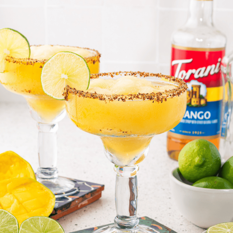 blended mango margarita in margarita glass with sugar or salt rim