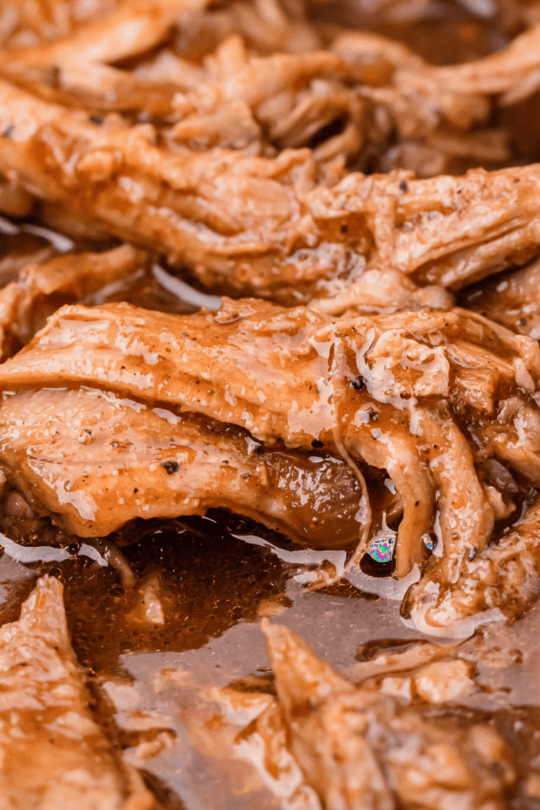 Shredded marinated pork with savory glaze and herbs