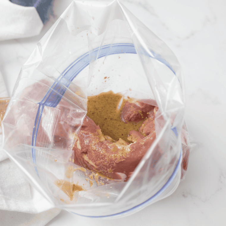 Maple mustard marinade brushed over pork tenderloin