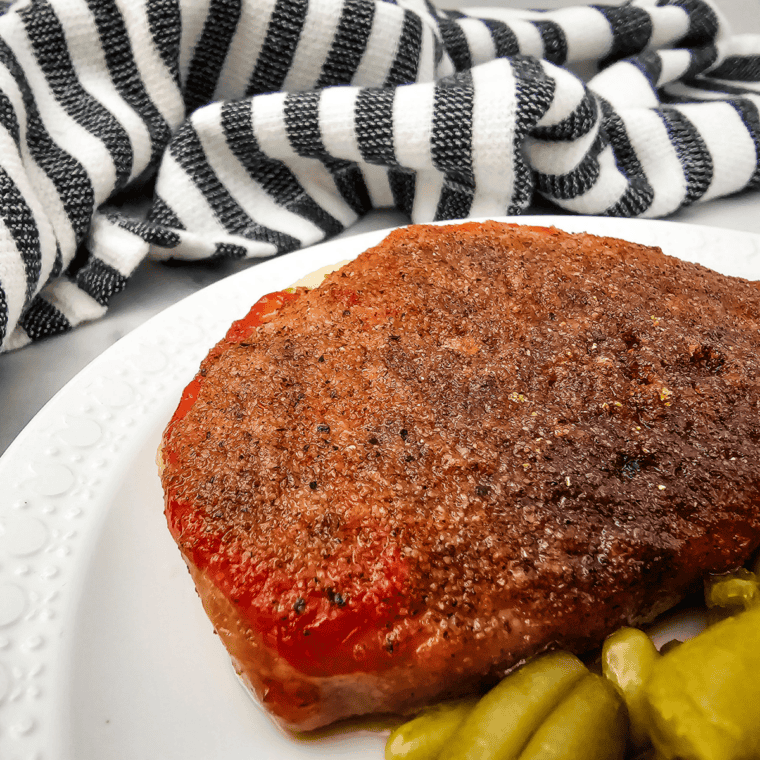Herb garlic lemon marinade on pork chops with fresh rosemary