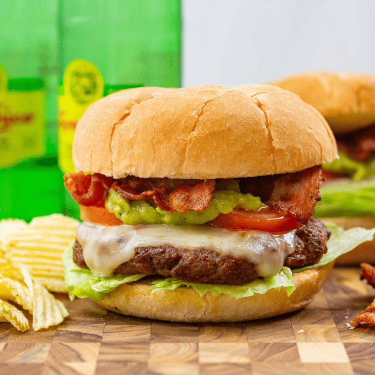 Assembled Air Fryer Black Currant Smashburger Slider with sauce, patty, cheese, pickles, and onion