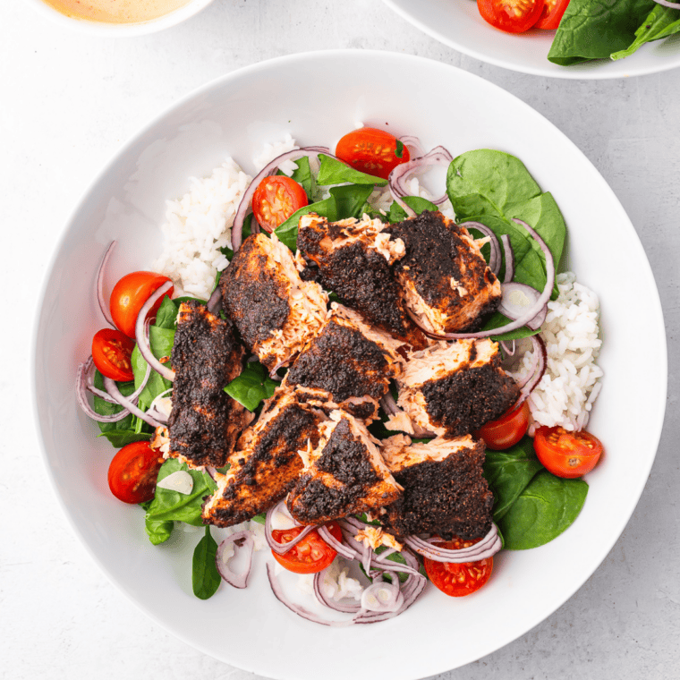 Air fryer Jack Daniel's glazed salmon served over white rice with roasted vegetables on the side