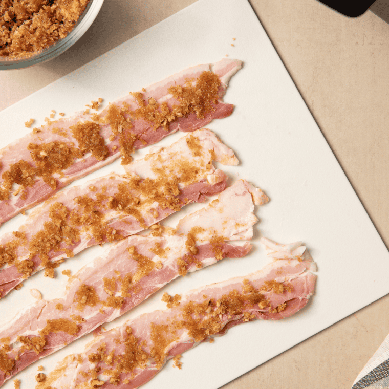  Brown sugar, chopped pecans, black pepper, and cayenne stirred together in a small bowl for praline bacon