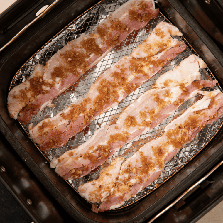 Brown sugar and pecan mixture pressed onto the tops of bacon strips in the air fryer