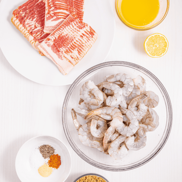 Ingredients for bacon wrapped shrimp with cream cheese &mdash; raw shrimp, bacon, cream cheese, jalape&ntilde;o, and chili sauce