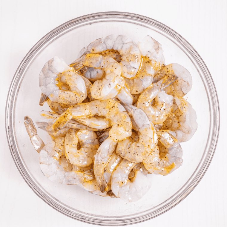 Cutting a pocket into the back of a raw shrimp with a paring knife