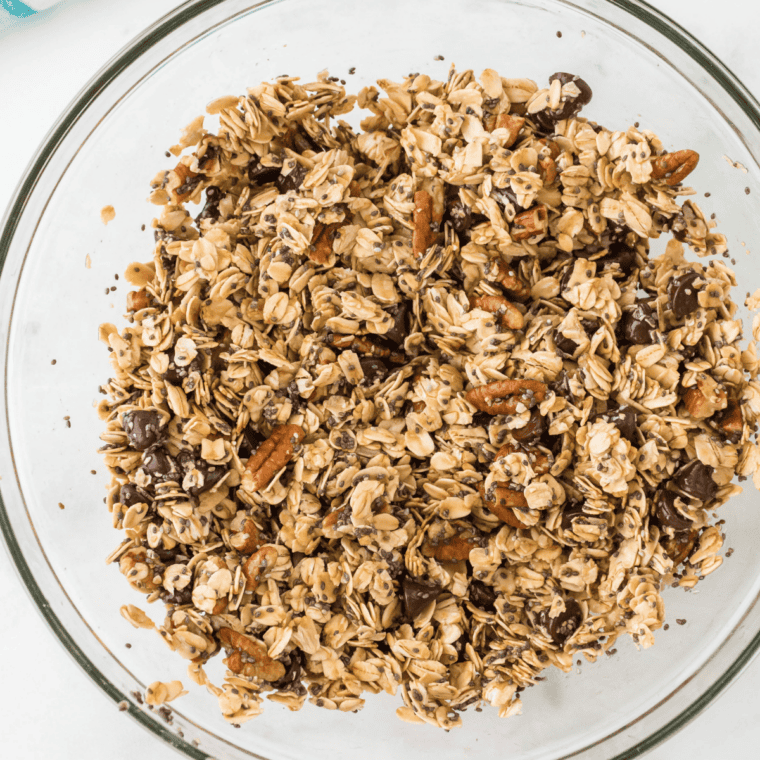 Wet maple mixture poured over oats and tossed to coat for copycat granola