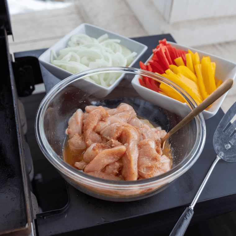 Blackstone griddle preheating with water droplets sizzling on the hot surface