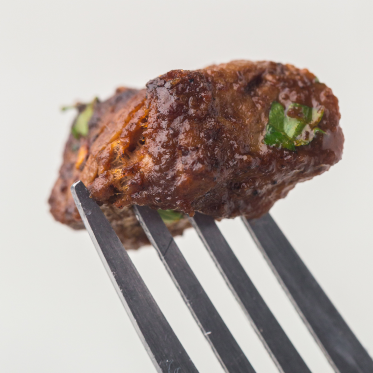 Tender garlic butter steak bites cooking on a hot Blackstone griddle