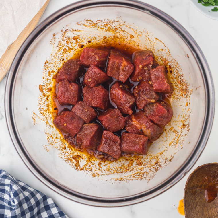 Marinating the steak in sauce.
