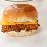 Homemade copycat Burger King fish sandwich cut in half showing the crispy panko pollock fillet inside