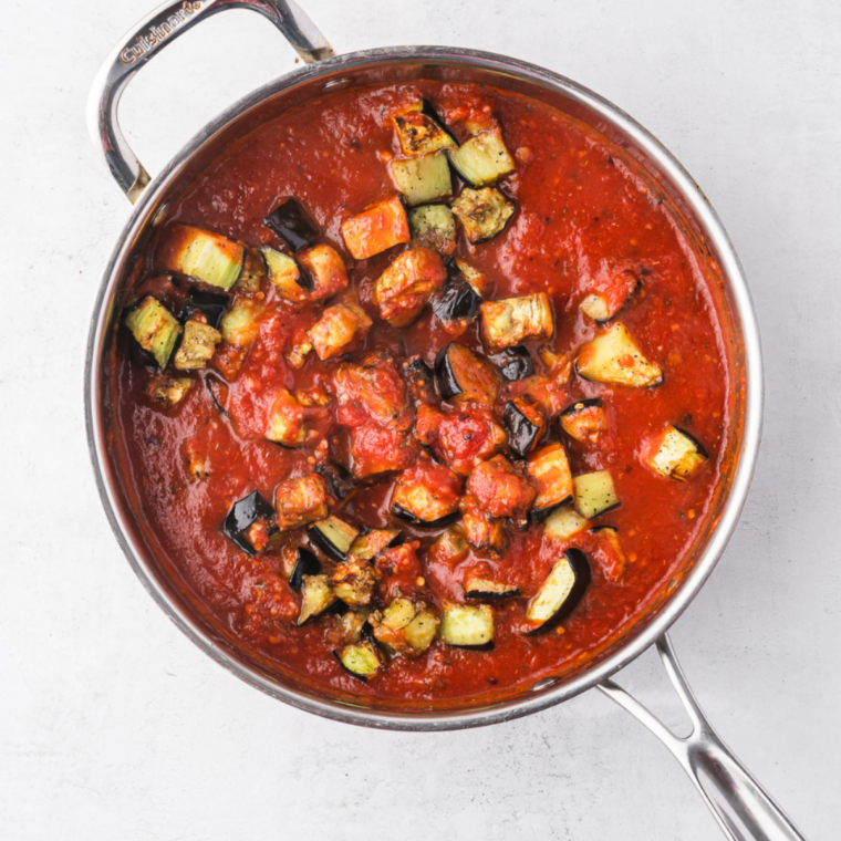 Marinara sauce gently simmering on low heat and thickening in the saucepan