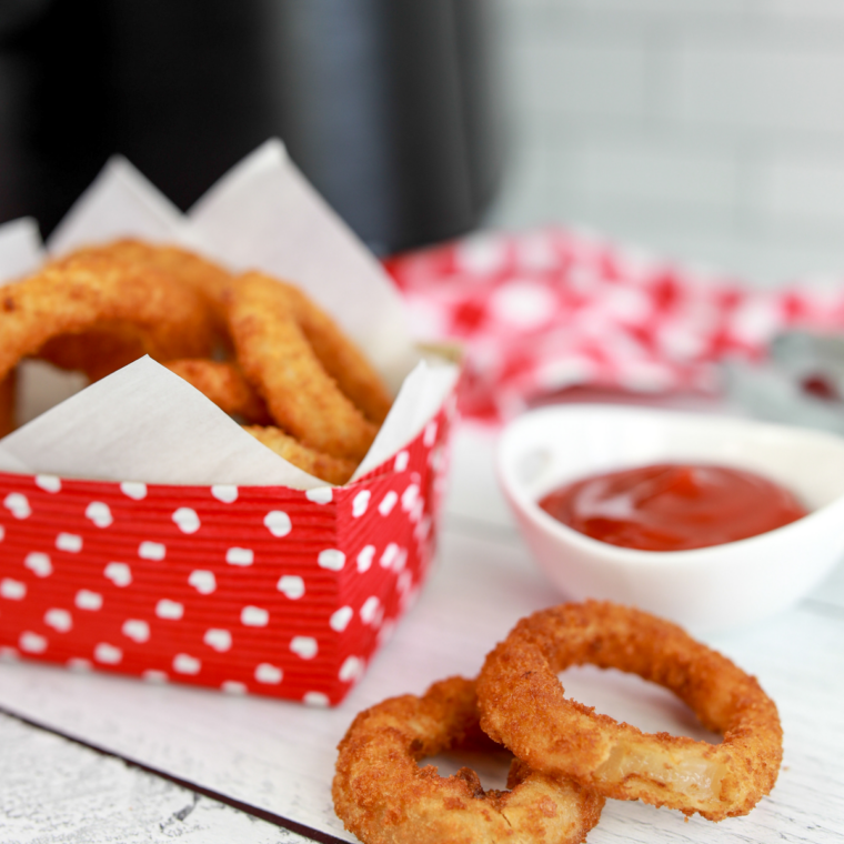 Close-up of marinara dipping sauce paired with golden fried mozzarella sticks