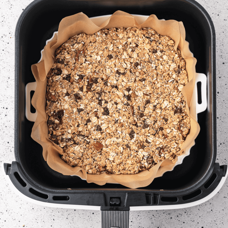 Copycat KIND granola clusters toasting in the air fryer basket.